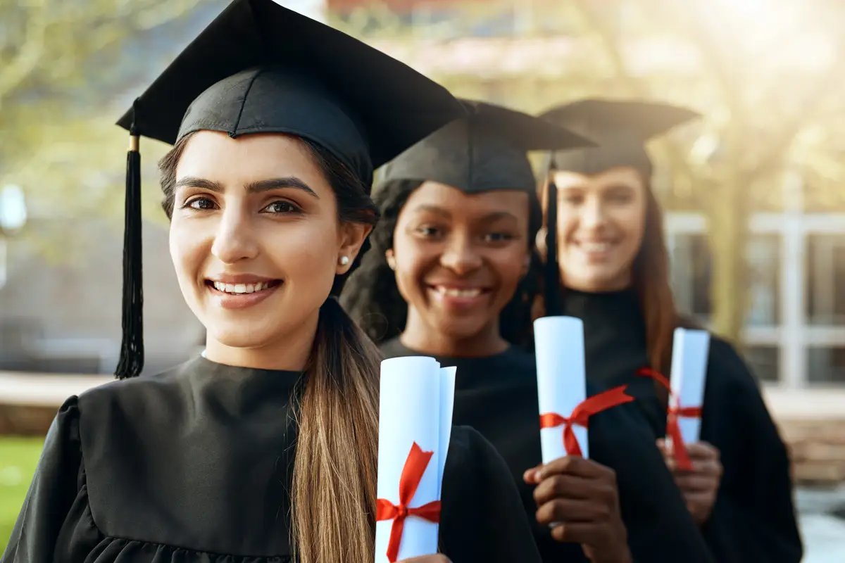 Students women and happy for graduation in row on campus with celebration and success People college and university classmate on portrait with smile for qualification or certificate competition